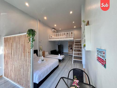 a bedroom with a bed and a bunk bed at Loft & Cozy Stay near Lee Garden in Hat Yai