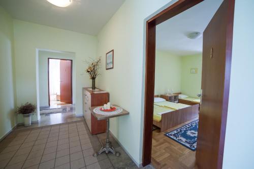 a room with a bed and a table in it at Guest House Hodak in Rakovica