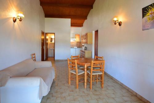 a living room with a couch and a table and chairs at Motel de Porticcio in Porticcio