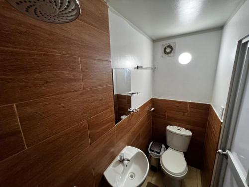 a bathroom with a toilet and a sink and a mirror at Huamanga plaza in Ayacucho