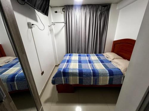 a small room with a bed and a window at Huamanga plaza in Ayacucho