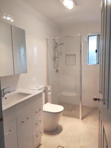 a bathroom with a shower and a toilet and a sink at Gaia's House self contained unit in Brisbane