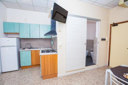 a small kitchen with a sink and a refrigerator at Residence Daniele in Bellaria-Igea Marina