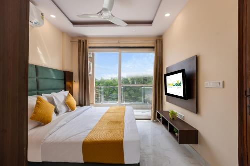Televisyen dan/atau pusat hiburan di Limewood Stay Service Apartment 1BHK - Millennium City Centre