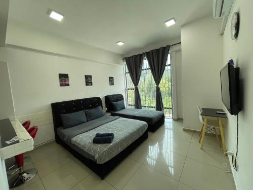 a living room with a bed and a tv at GR studio APARTMENT kompleks MUTIARA gua MUSANG in Gua Musang
