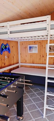 a room with two bunk beds and a ladder at EchoBay nr 2 - child-friendly house close to the beach in Jerup