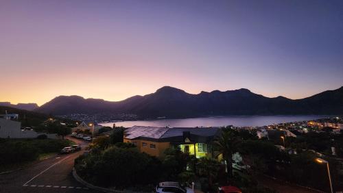 a view of a city and a lake at sunset at Hout Bay Breeze Guest House in Hout Bay