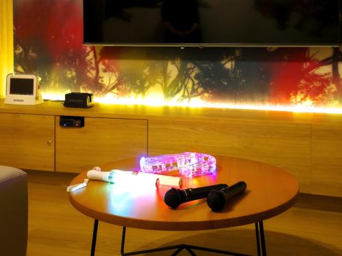 a coffee table in a living room with a tv at HOTEL BOTA 豊橋 -Adult Only- in Toyohashi