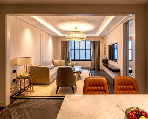 a living room with a couch and a table at Fairmont Mumbai in Mumbai