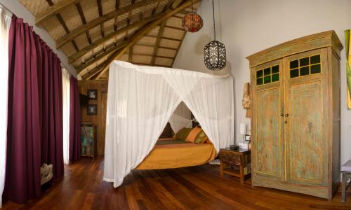 a bedroom with a bed with a canopy at 100% Fun in Tarifa