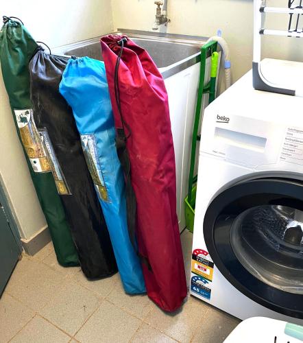 three bags sitting next to a washing machine at Coastal Retreat- Beach, Lagoon & Cafes Just Steps from Your Door! in Narrabeen