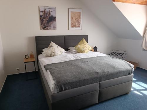 a bedroom with a large bed with two pillows at Hotel Baroko in Prague