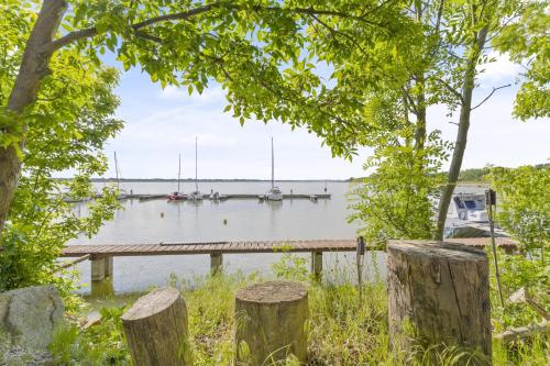a dock on a lake with boats in the water at Cozy river-view suite in Šamorín