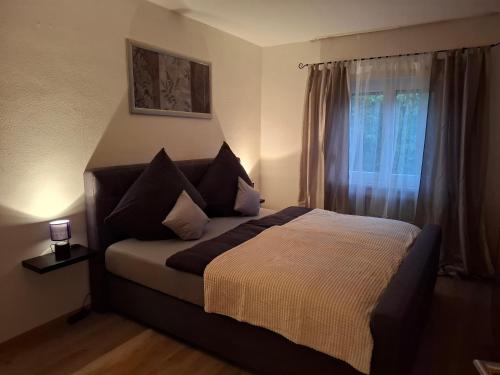 a bedroom with a large bed with a window at Ferienwohnung am Bach in Altenkunstadt