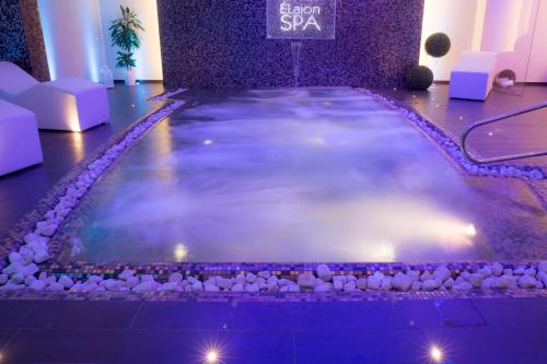 a large pool of water in a room with lights at Hotel Degli Ulivi in Ferrandina
