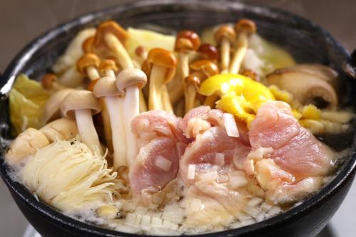 a black bowl of food with meat and mushrooms at KAMENOI HOTEL Itako in Itako