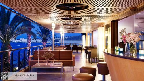 a restaurant with a view of the ocean on a cruise ship at Spetses Hotel in Spetses
