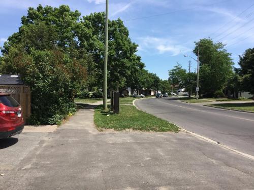 a street with a car parked on the side of the road at Mac B&B in Ottawa