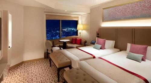 a hotel room with two beds and a window at Yokohama Royal Park Hotel in Yokohama
