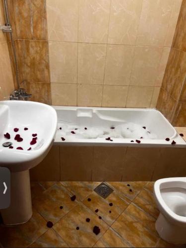 a bathroom with a sink and a bath tub with debris on the floor at Bliss Spot Vacation Home in Al Ain