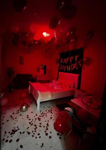 a red room with a bed with blood on the floor at Bliss Spot Vacation Home in Al Ain