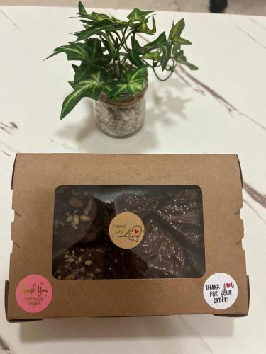 a box with a potted plant on a table at Bliss Spot Vacation Home in Al Ain
