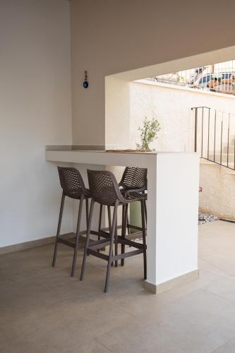 a kitchen with a counter with chairs around it at Casa Eva in Opric
