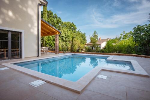 a swimming pool in the backyard of a house at Casa Eva in Opric