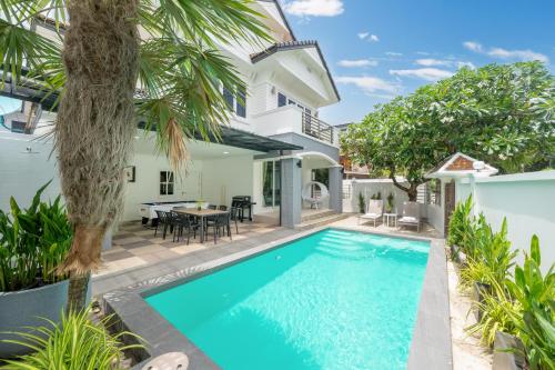 an exterior view of a villa with a swimming pool at 7BR Grand Pool Villa in heart Patong in Patong Beach