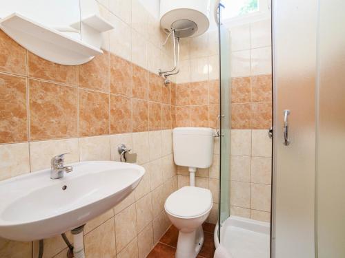 a bathroom with a toilet and a sink and a shower at Apartments Iva in Kotor
