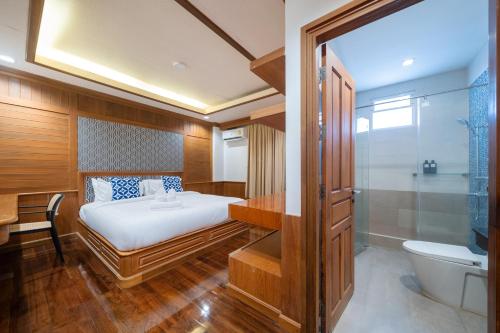 a bedroom with a bed and a tub and a toilet at 7BR Grand Pool Villa in heart Patong in Patong Beach