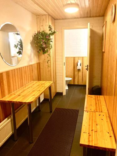 a room with wooden tables and a bathroom with a toilet at Moomin Lover Home in Central Helsinki - Pool & Sauna in Helsinki