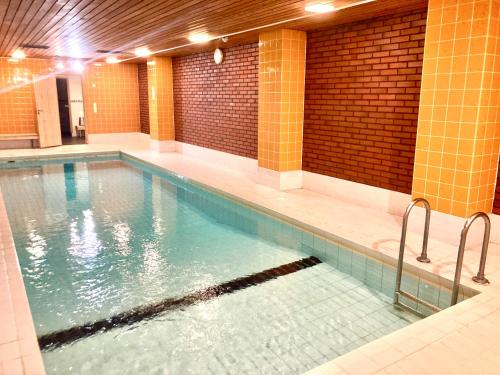 a large swimming pool in a building at Moomin Lover Home in Central Helsinki - Pool & Sauna in Helsinki