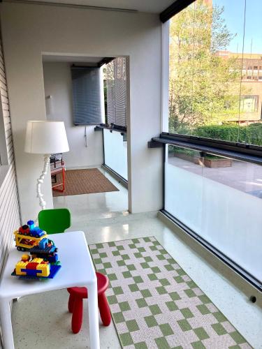 a room with a table and a chair and a window at Moomin Lover Home in Central Helsinki - Pool & Sauna in Helsinki
