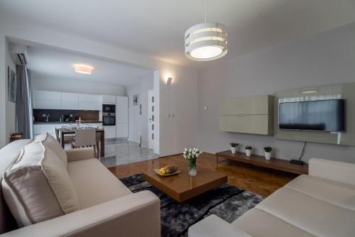a living room with a white couch and a table at Villa Solis in Split