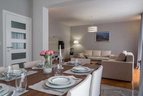 a dining room and living room with a table and chairs at Villa Solis in Split