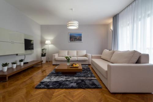 a living room with a white couch and a table at Villa Solis in Split
