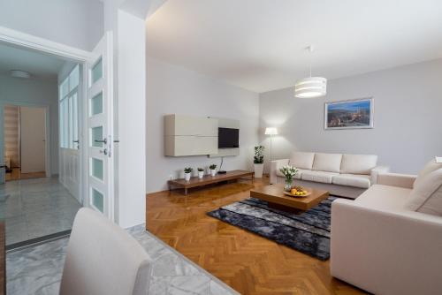 a living room with a couch and a table at Villa Solis in Split
