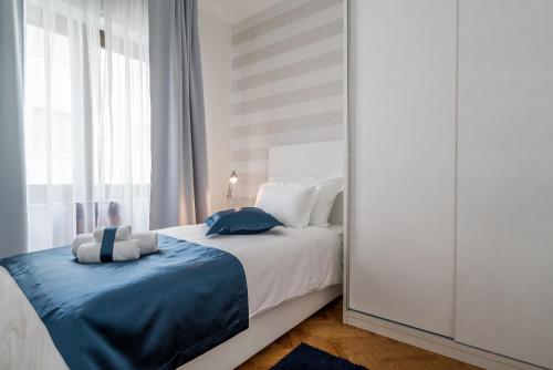 a bedroom with a bed and a large window at Villa Solis in Split