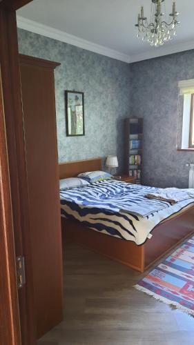 a bedroom with a bed and a chandelier at Halal House Vip in Qusar