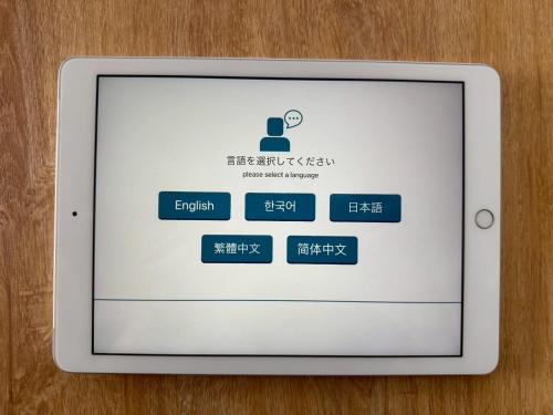 a tablet computer with the login screen on it at Good Stay Apartment in Nichinan