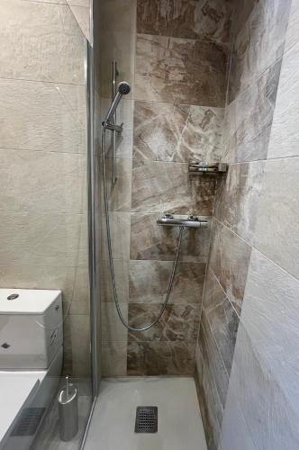 a bathroom with a shower and a toilet at Family friendly duplex with free parking in Leukerbad