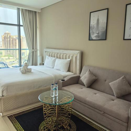 a living room with a bed and a couch at 7 Palm Jumeirah in Dubai