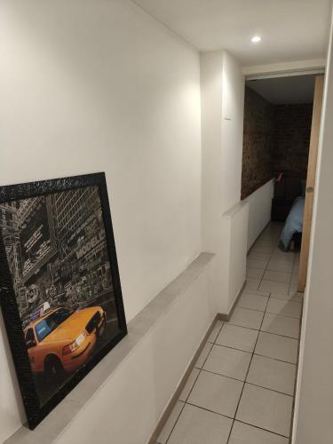 a hallway with a picture of a car on the wall at Les Pierres de Rinaldi in La Celle-sous-Gouzon