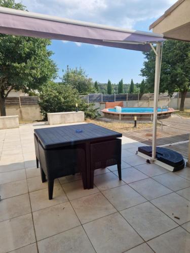 a ping pong table sitting on a patio at Villa de luxe aux portes d'Uzès in Serviers-et-Labaume