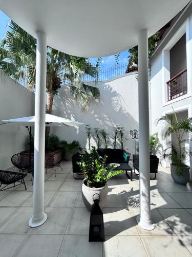 a patio with tables and chairs and umbrellas at Camellia Residencies Colombo Sri Lanka in Colombo