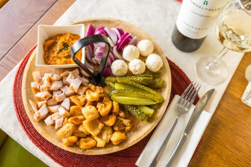a plate of food with meat and vegetables on a table at Pensiunea Sibiel in Sibiel
