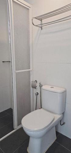 a white toilet in a bathroom with a shower at PD D'Wharf The Bay Superior Queen Room SeaView Balcony in Port Dickson