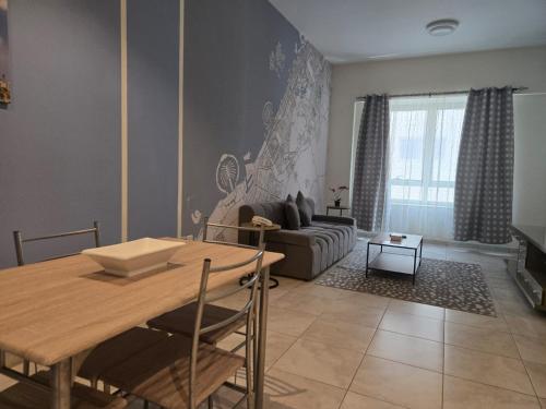 a living room with a table and a couch at Al Raya Hotel Apartments in Dubai