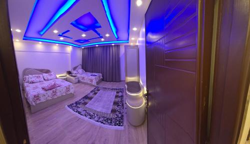 a room with a purple ceiling and a room with a couch at Apartment with panoramic sea view sidi bshr Families only in Alexandria